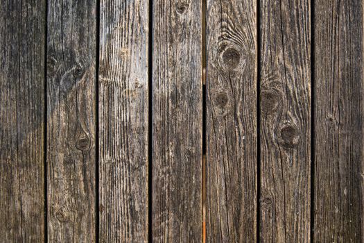 Close-up of weathered wooden planks showcasing unique texture and grain patterns.
